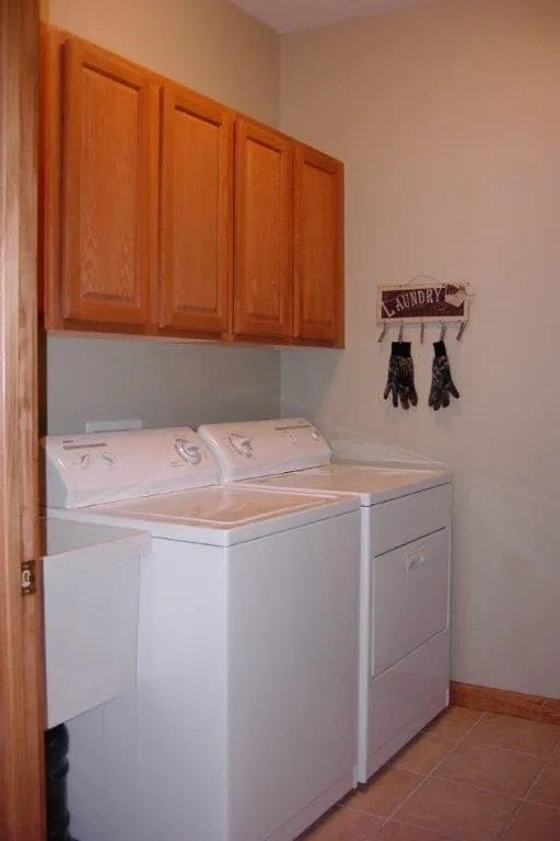 A room with two white washer and dryer.